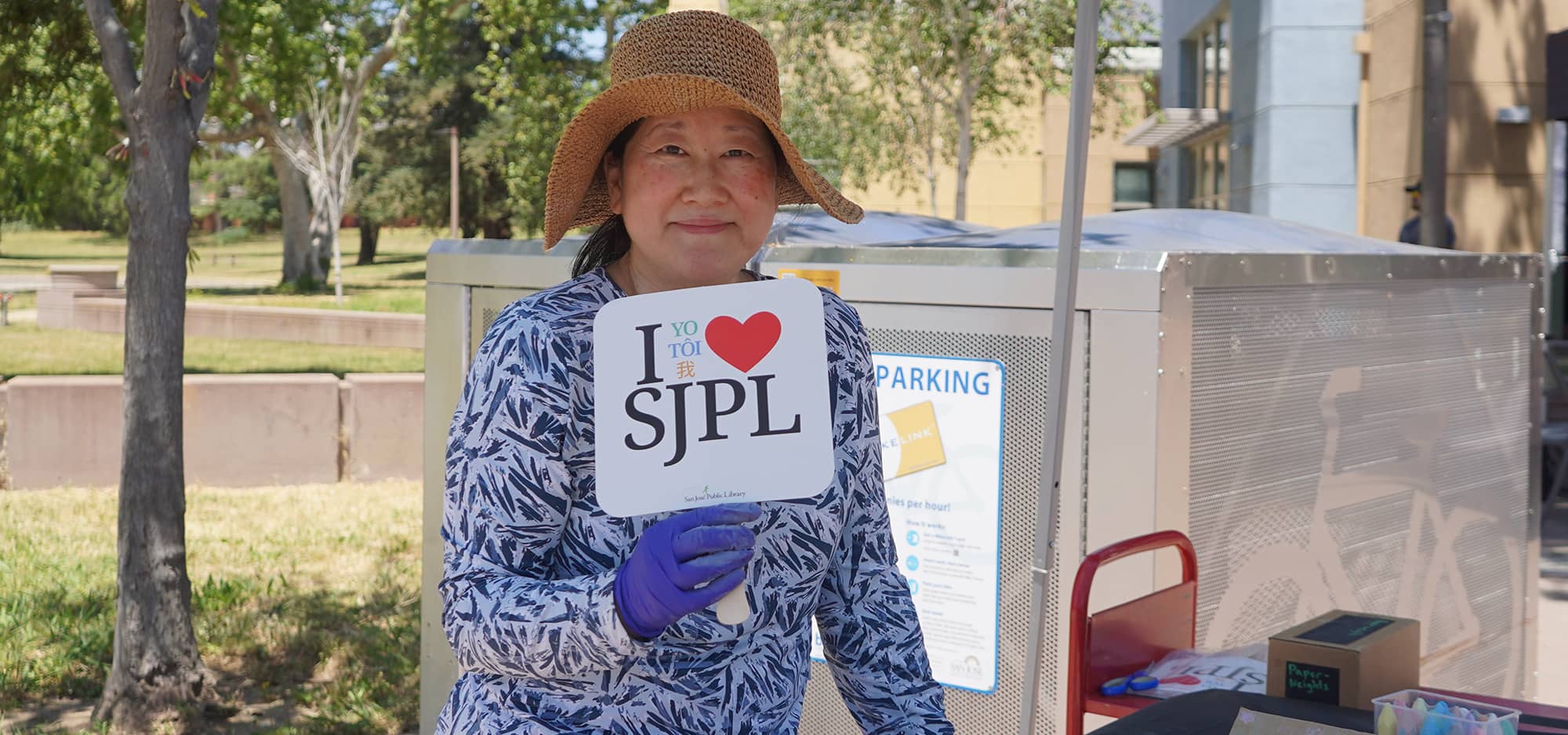 Woman holding an "I heart SJPL" sign.