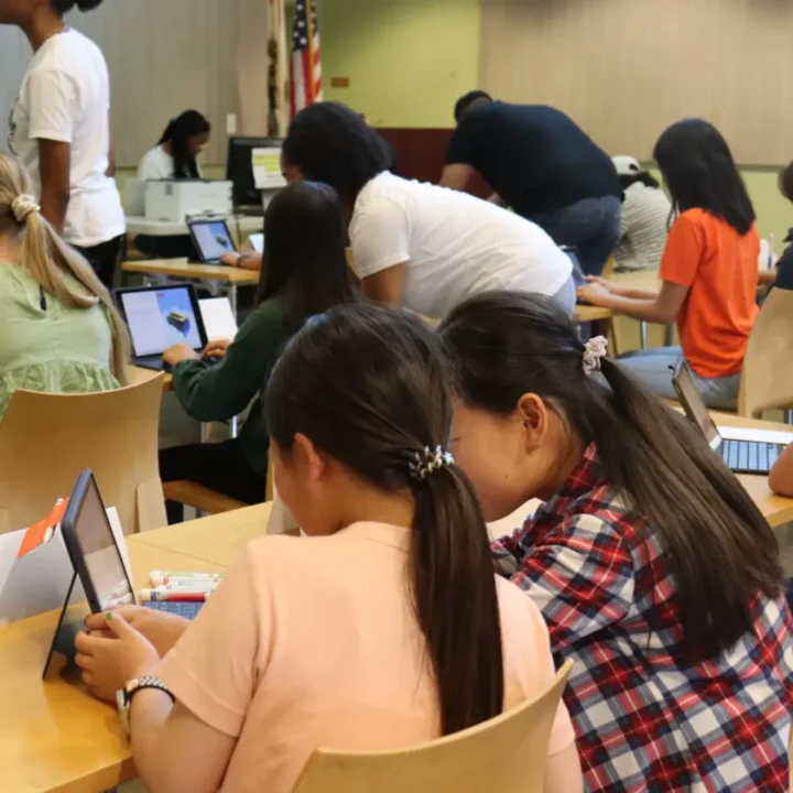 Students working together on a tablet computer.