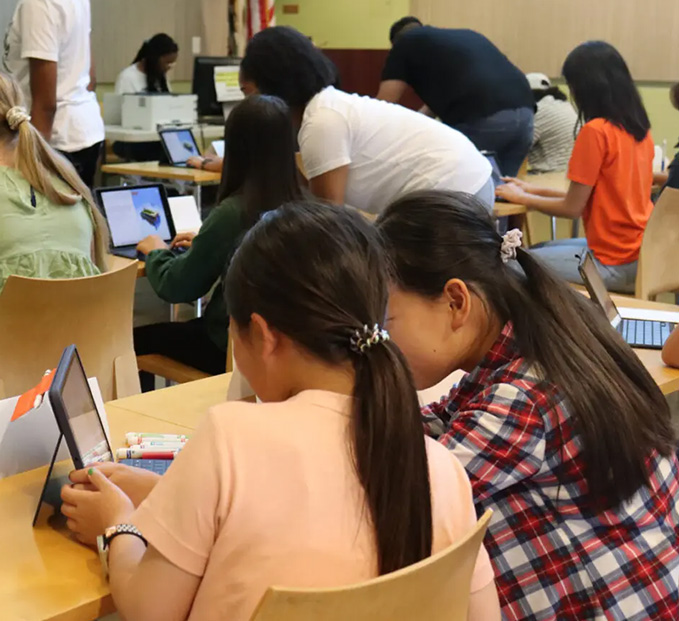 Two students working on a tablet computer.